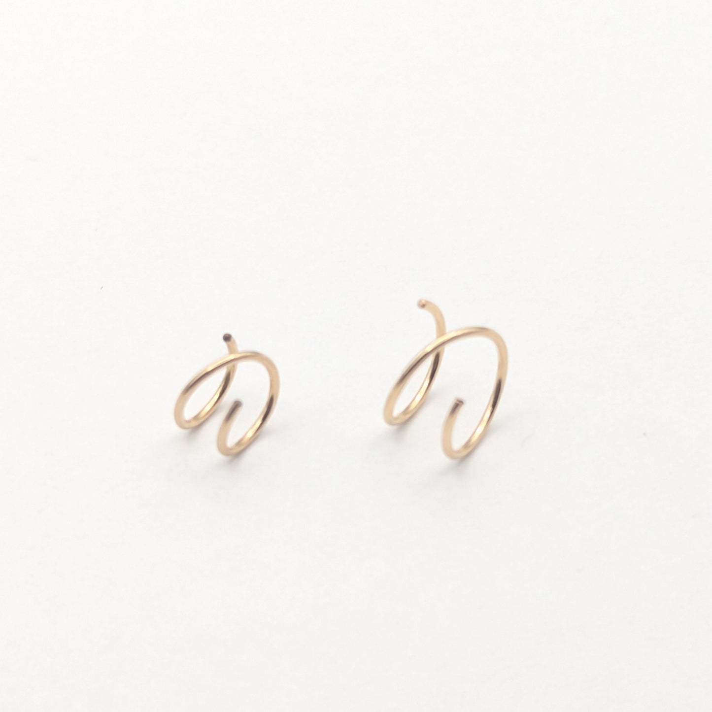 Gold filled wire earrings on a white background